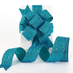 blue glittered ribbon in front of a white box