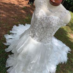 a mannequin is dressed up in a white dress