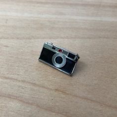 a camera sitting on top of a wooden table