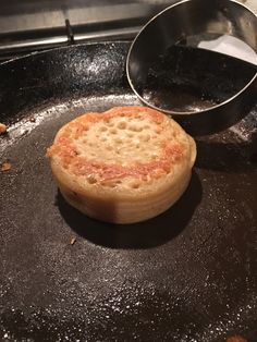 a frying pan with some food on it and a spatula next to it