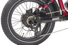 the front wheel and rear tire of a red bike with chain links on white background