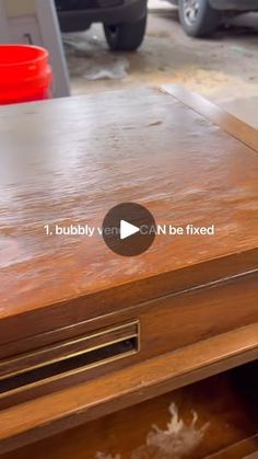 a close up of a wooden table with drawers