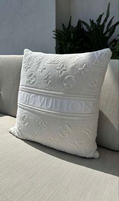 a white pillow sitting on top of a couch