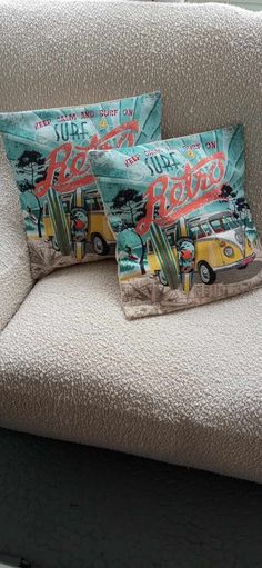 two pillows sitting on top of a couch