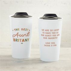 two travel mugs sitting on top of a table next to each other with the words, best and aunt