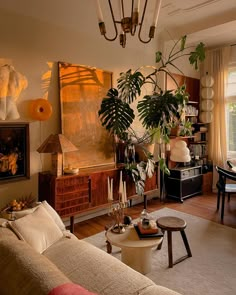 a living room filled with furniture and lots of plants