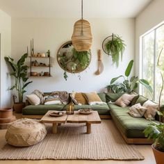 a living room filled with lots of green furniture and potted plants on the wall