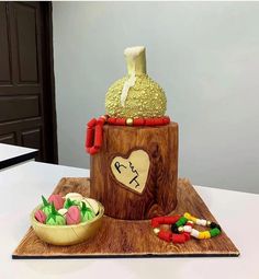 there is a cake made to look like a tree stump with candy in front of it