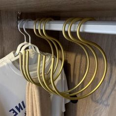 some clothes hangers are hanging on a rail