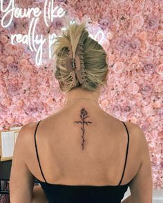 a woman with a cross tattoo on her back