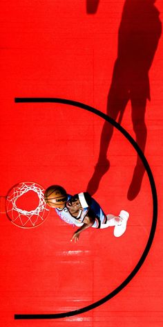 a basketball player is going to dunk the ball in front of an overhead view