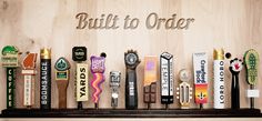 there are many different types of items on the shelf in front of this sign that says, built to order