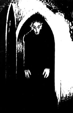 a black and white image of a person in a tunnel