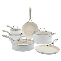 an assortment of white pots and pans on a white background with one empty frying pan