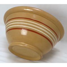 a yellow bowl with red and white stripes on it