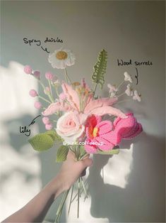 a hand holding a pink crocheted flower bouquet with the words spring written on it