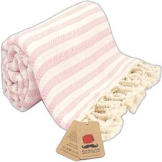 a pink and white striped blanket with a tag on the bottom that says moustache