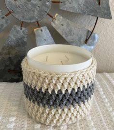 a white candle sitting on top of a table