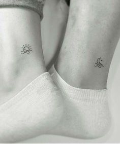 two small sun and moon tattoos on their legs, both with the same tattoo design