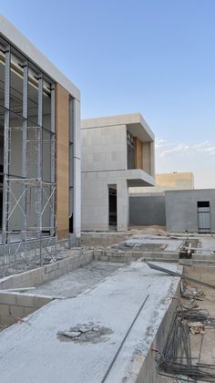 a building under construction with scaffolding around the perimeter and windows on each side