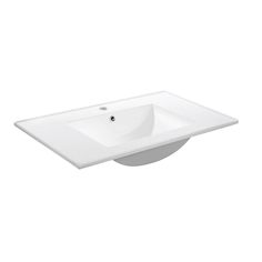 a white bathroom sink sitting on top of a counter next to a faucet