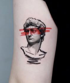 a woman's arm with a tattoo of a bust wearing red eyeliners