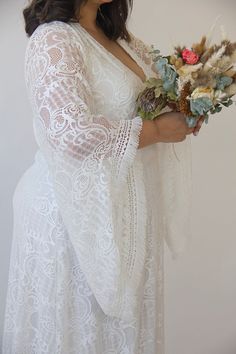 "Model size 3XL-4XL (US 18-20) Goddess boho dress with fringed bell sleeves Bridal kaftan maxi lace dress Bohemian plus size wedding dress, boho bride Vintage style wedding lace maxi dress. Made from high-quality floral lace fabric. ♥ V-neckline ♥ Depth of cleavage - 13.3'' / 34 cm ♥ Bat lace sleeve ♥ Length of sleeves front - 23.6'' / 60cm ♥ Length of sleeves back - 26.7'' / 68cm ♥ Maxi length dress ♥ Boho fringe details ♥ Lining made of high-quality viscose Lycra fabric- very comfortable ♥ Col Bridal Kaftan, Wrap Wedding Dress, Bohemian Lace Dress, Bride Vintage, Wedding Renewal, Plus Size Wedding Dress, Wedding Dress Boho, Floral Lace Fabric, Bat Sleeves