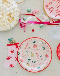 a table topped with plates covered in frosting next to christmas decorations and other items