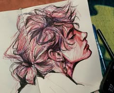 a drawing of a woman's head in colored pencils on top of a piece of paper