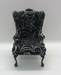 a black and white chair with spider webs on it