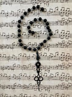 A chain of large, black, spherical rosary beads (attached to each other by silver links). The clock hand has a Victorian Gothic style to it and is attached by a silver link to a single blackened metal hand connector. Fits with Victorian, Gothic, or Steampunk styles! Clock hand is black on both sides. Victorian Gothic Style, Rosary Beads, Victorian Gothic, Steampunk Fashion, Rosary, Gothic Fashion, Necklace Etsy, Jewelry Necklace Pendant, Clock