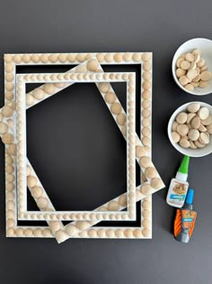 an art project made out of wooden beads and other items on a table with a black background