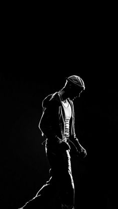 a man riding a skateboard down the side of a ramp in black and white