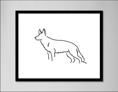 a black and white drawing of a dog in a frame on the wall above it