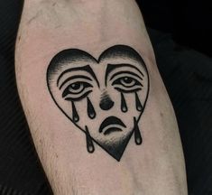 a man's arm with a black and white heart shaped tattoo on his left leg