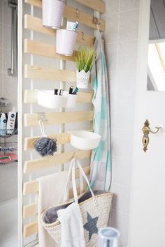 a bathroom with a towel rack and baskets on the wall