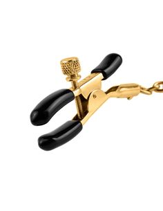 a pair of gold pliers with black handles on a white background and clippings