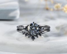 an engagement ring with black diamonds on it