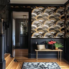 a room with black walls, wooden floors and an area rug that has a flower pot on it