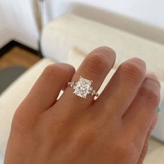 a woman's hand with a diamond ring on it