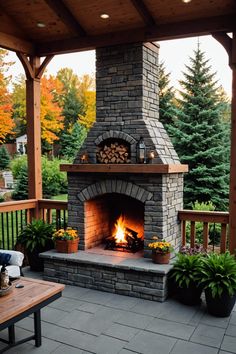 an outdoor fireplace with potted plants and trees in the background, on a patio