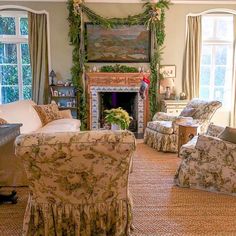 a living room filled with furniture and a fire place in the middle of a room