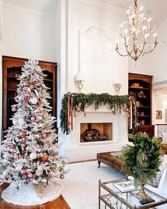 a living room decorated for christmas with a tree in the corner and fireplace mantel