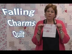 a woman holding up a piece of paper with the words falling charms quilt