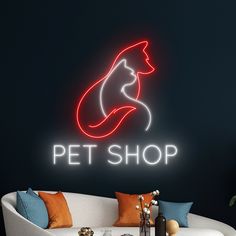 a neon sign that says pet shop with a cat on it