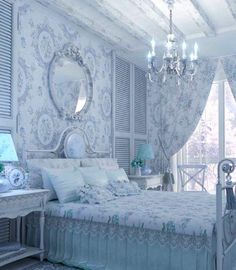 a bed room with a neatly made bed and a chandelier