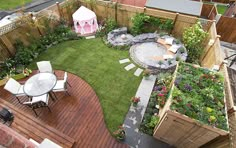 an aerial view of a backyard with a table, chairs and small garden area in the middle