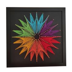 a multicolored starburst in a black frame