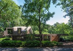 an artist's rendering of a house in the woods with trees and bushes surrounding it