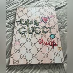 a gucci book on a bed covered in graffiti